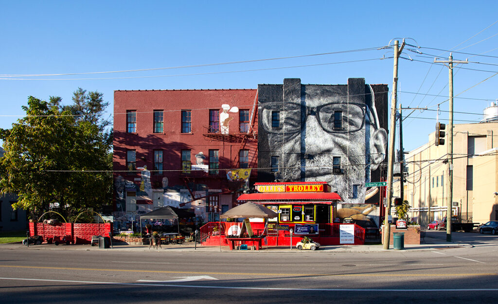 A mural depicting artist William Rankins Jr. on the side of Ollie's Trolley, seen from Liberty Street in Cincinnati, Ohio.