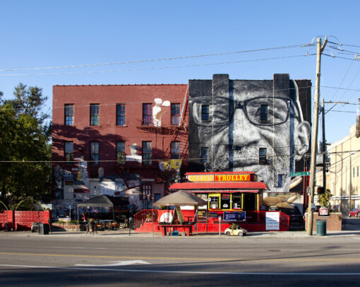 A mural depicting artist William Rankins Jr. on the side of Ollie's Trolley, seen from Liberty Street in Cincinnati, Ohio.